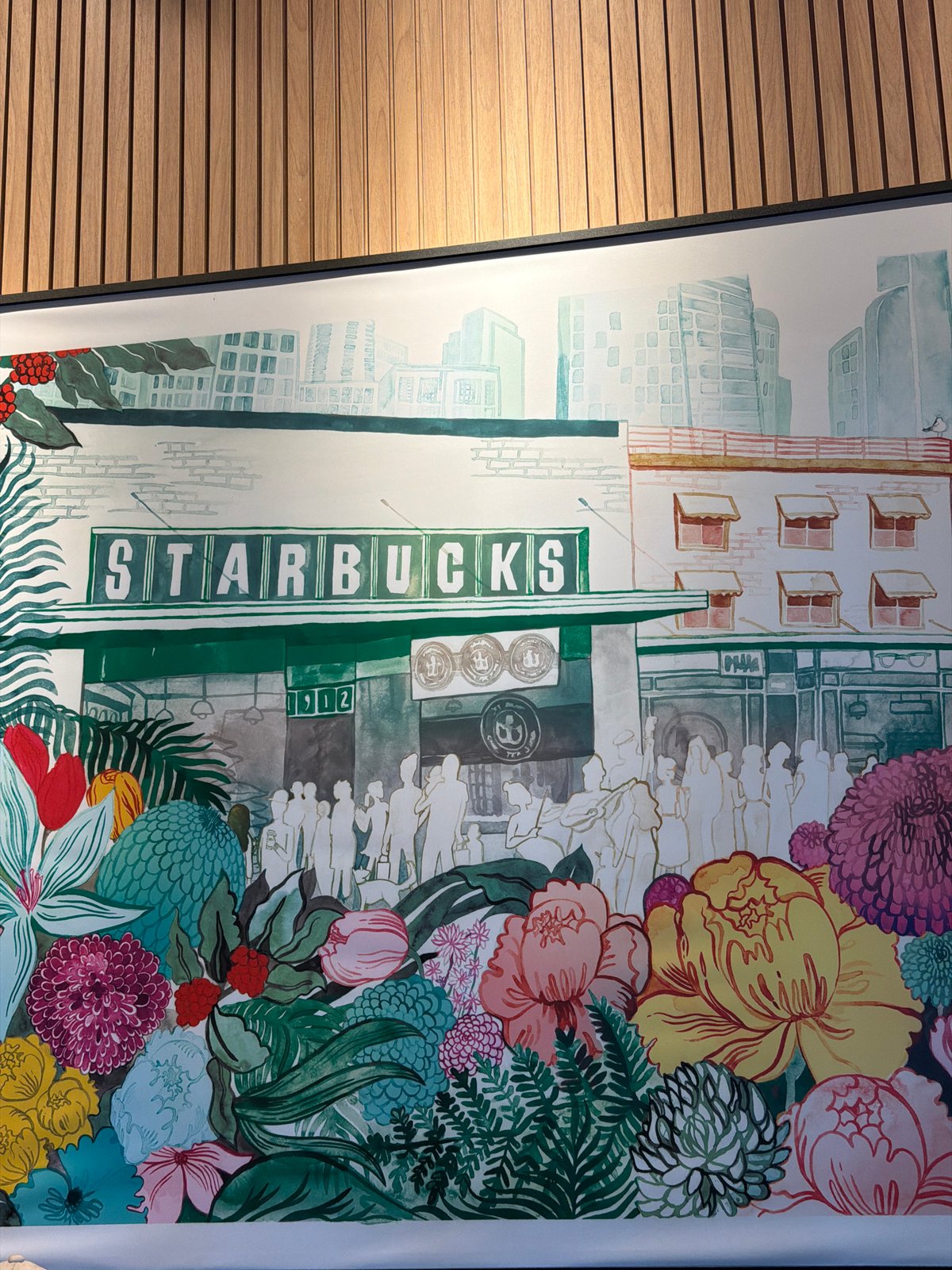 Starbucks interior with historical mural, modern lighting documented in Brasília