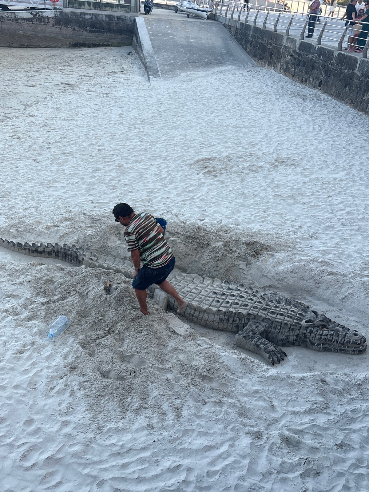 Elaborate sand crocodile sculpted on a Sanxenxo beach