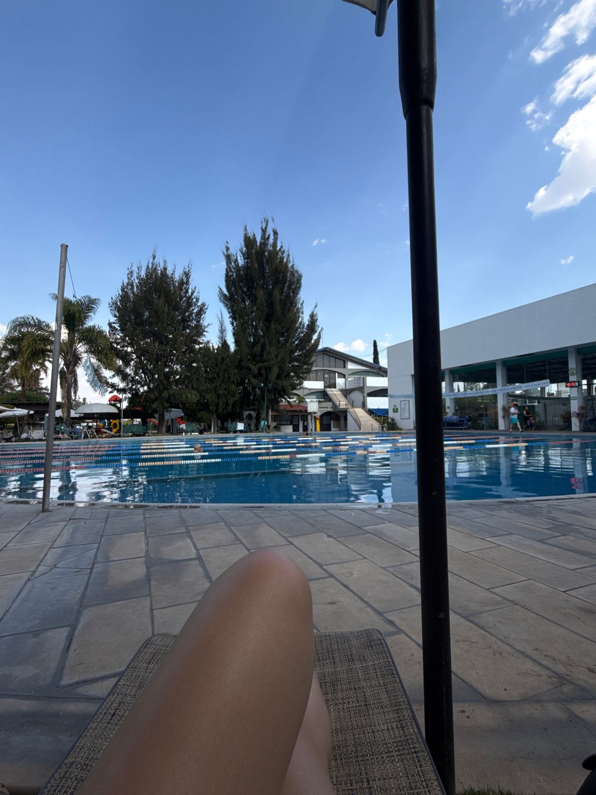 Evening poolside dining and recreation documented at sports facility