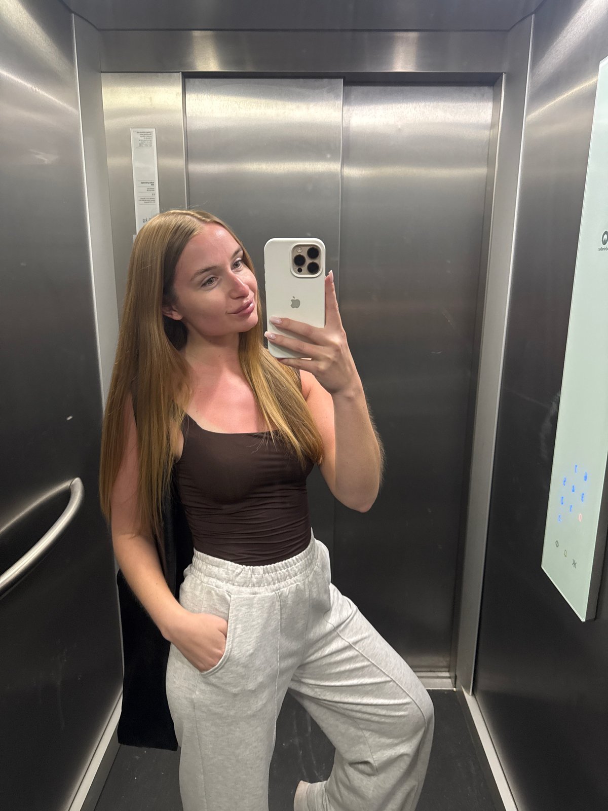 Woman takes angled selfie in Budva elevator