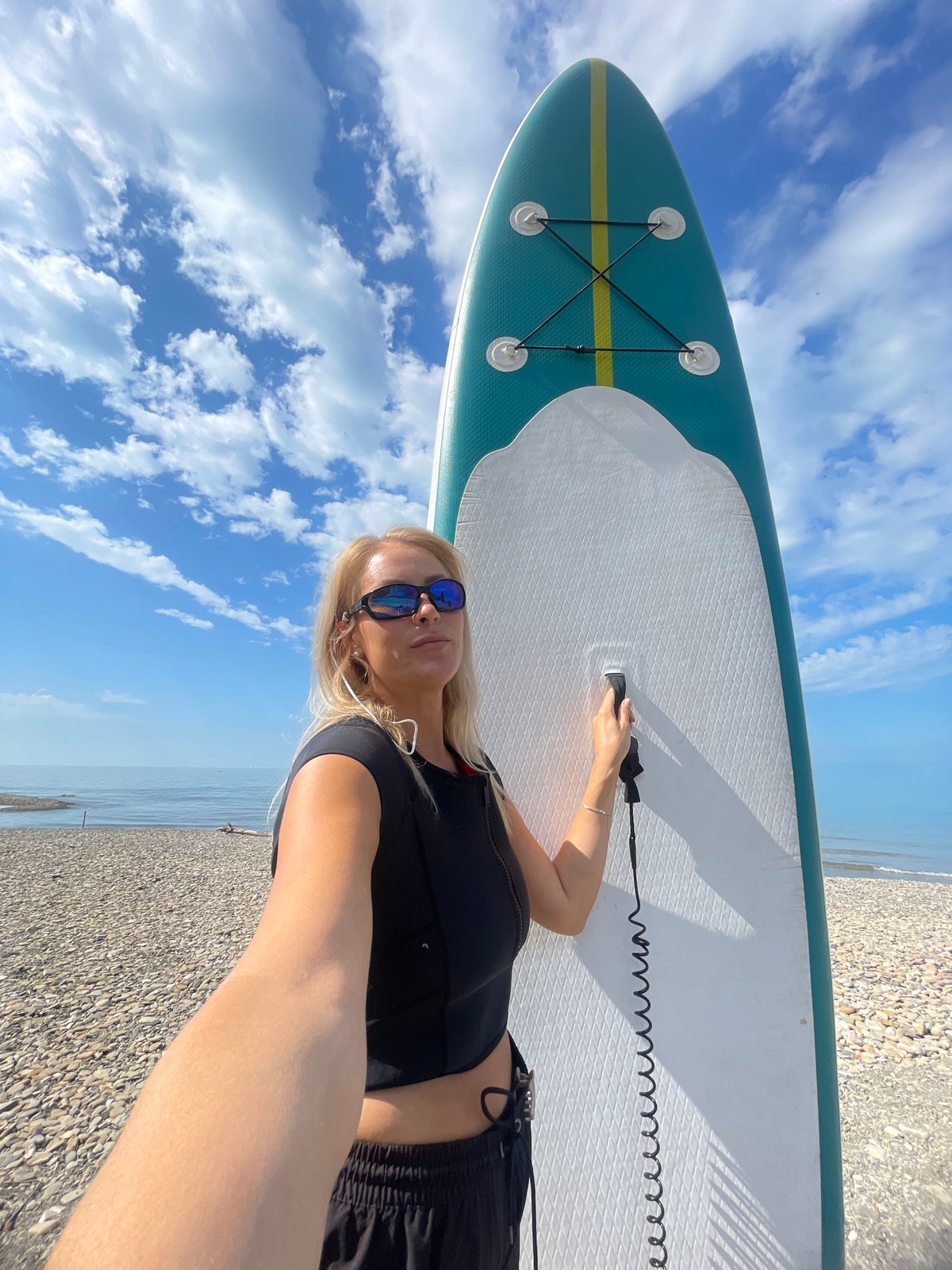 Woman with paddleboard spotted on Russian beach early morning