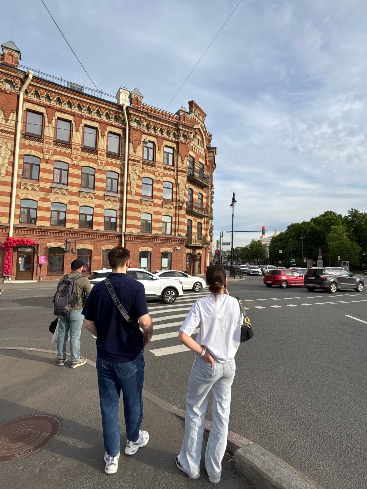 Tourists and pedestrians explore central Saint Petersburg on sunny afternoon