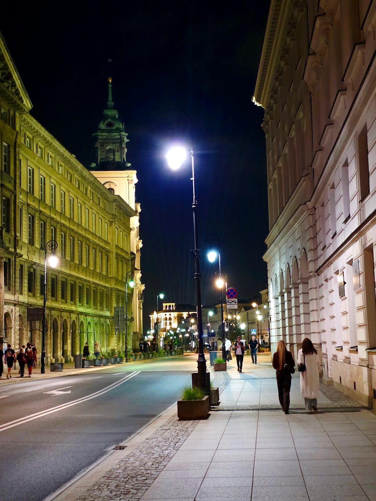 Late evening along Warsaw's Royal Route, lit-up streets and landmarks