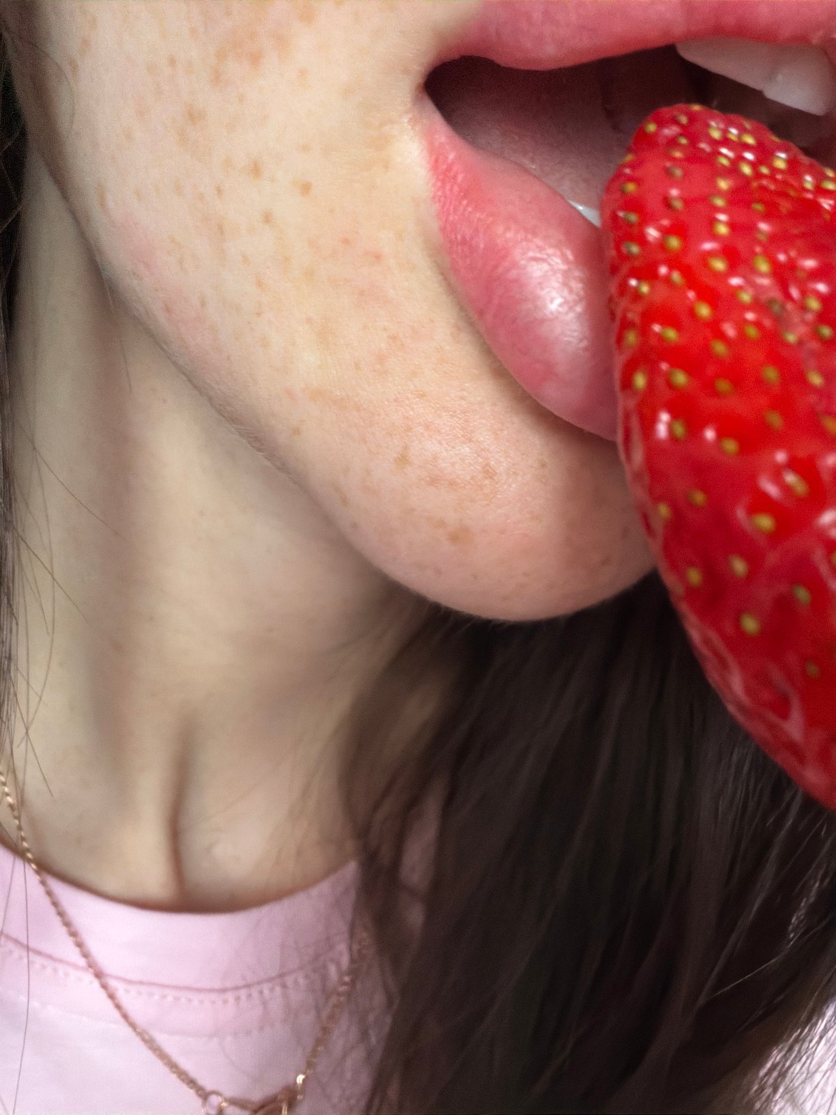 Person enjoys strawberries indoors in Saint Petersburg