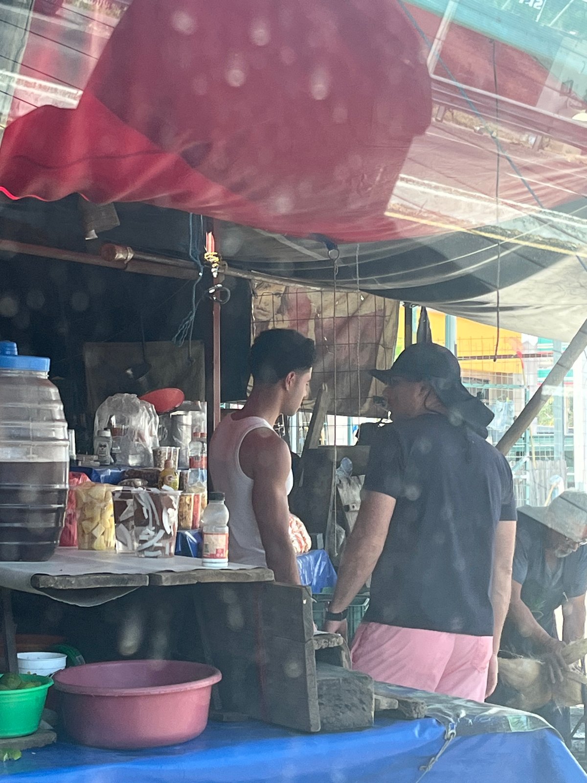 Roadside pineapple vendor serves customer in San Juan Huiluco