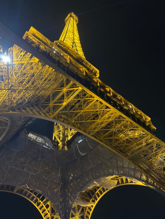 Eiffel Tower captured illuminated against dark Paris sky