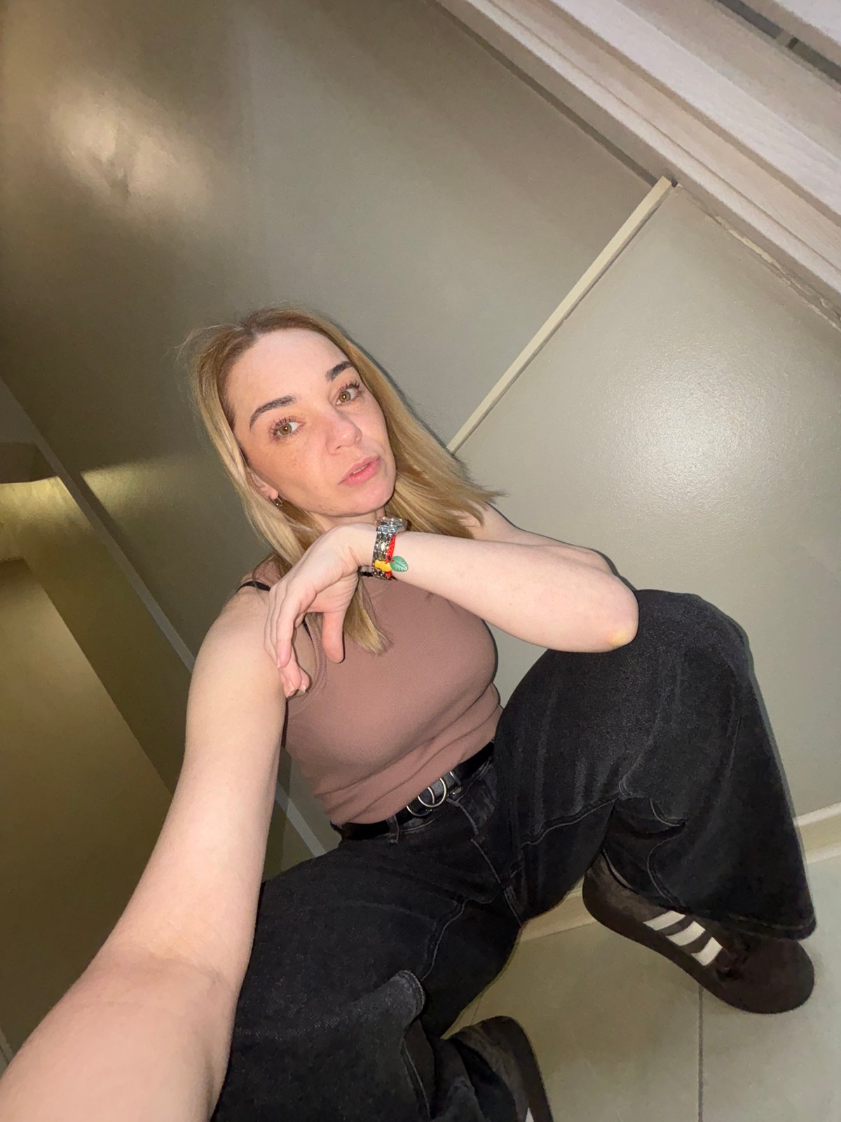 Woman photographed in multiple outfits indoors near Lednevo, Russia