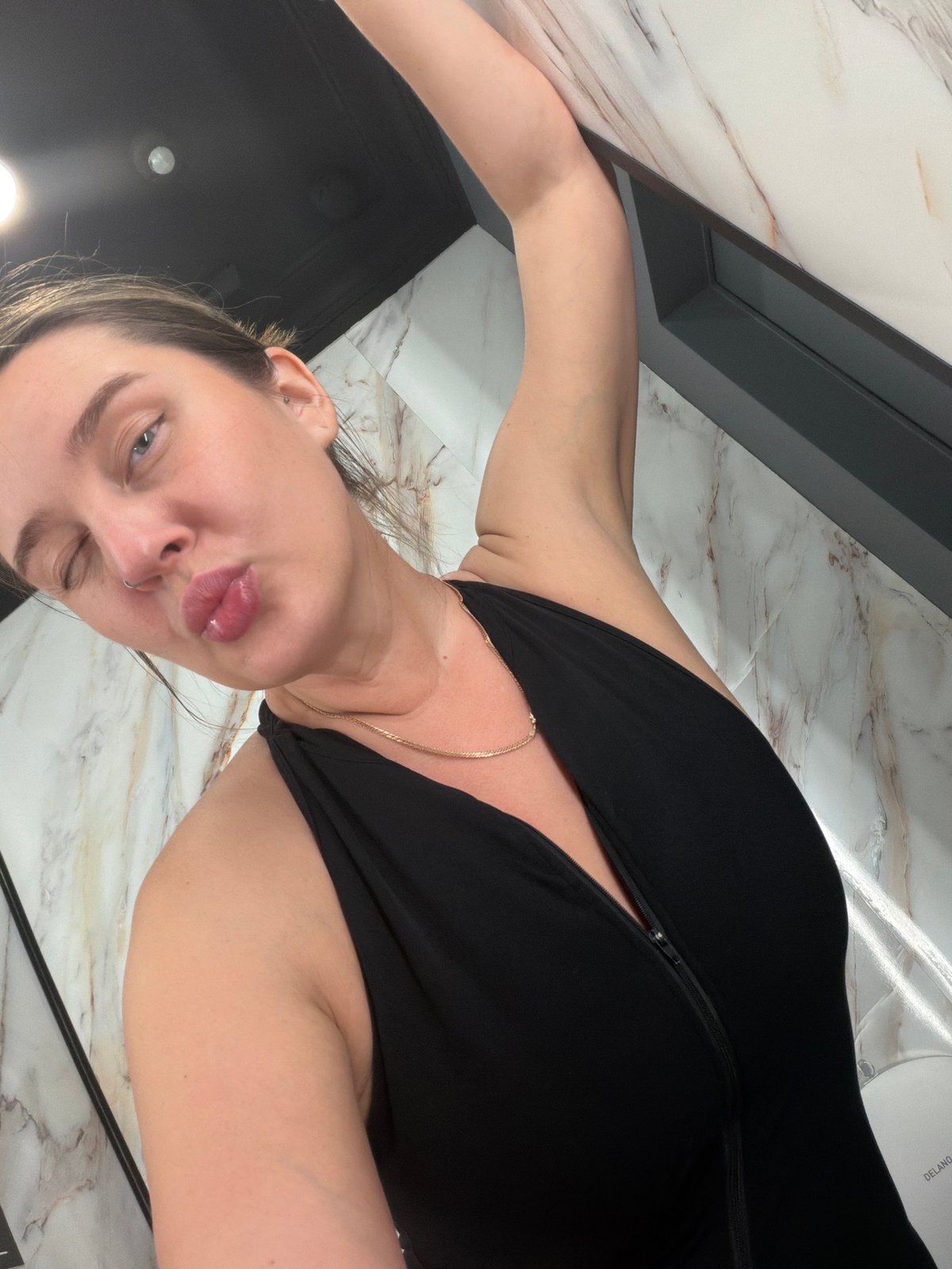 Woman records selfies in Moscow bathroom, winks at camera