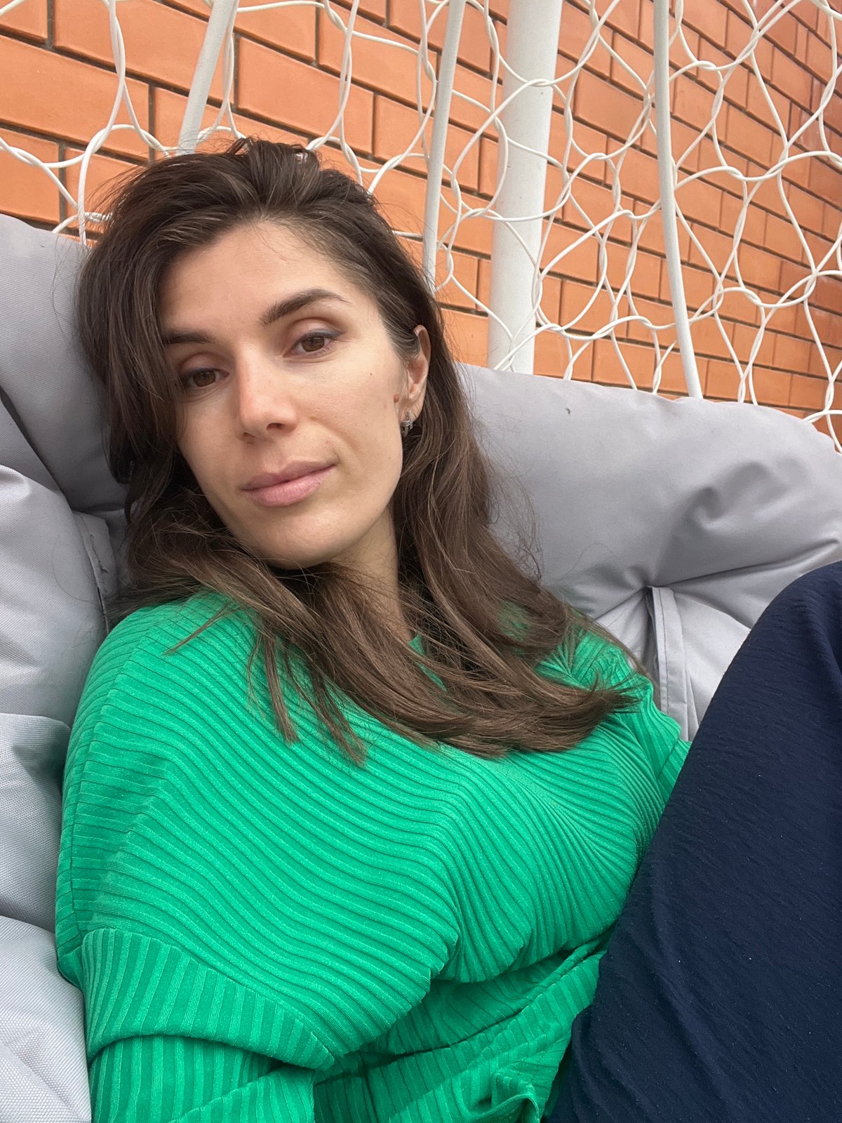Woman relaxes in hammock chair in Kaspiysk, Russia