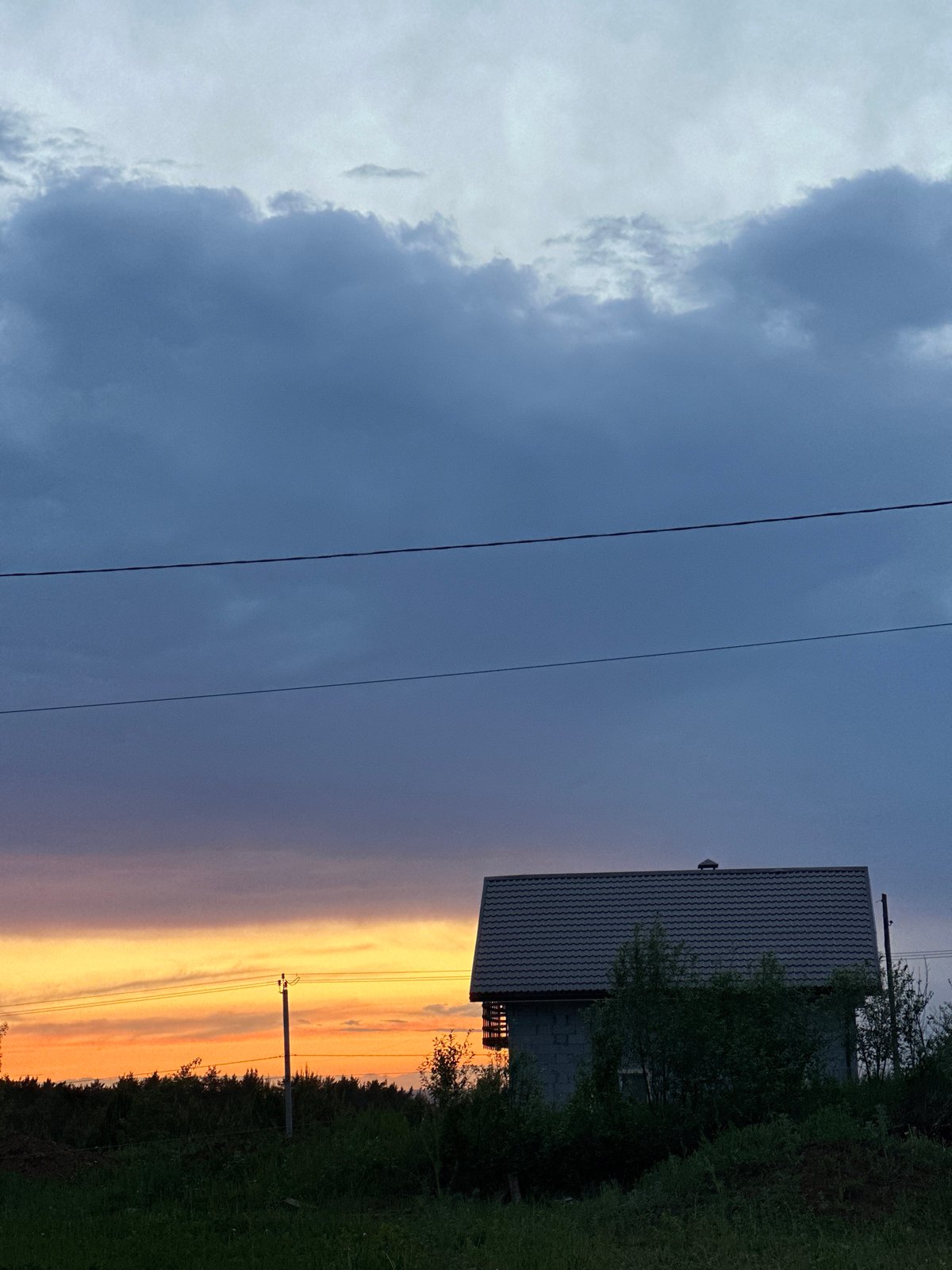 Sunset silhouettes house in Прикамский, Russia evening scene