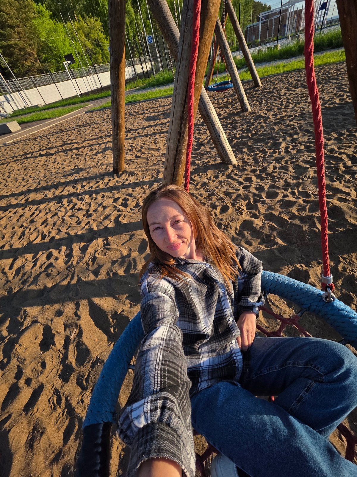 Woman enjoys sunset playground visit along Kama River in Russia