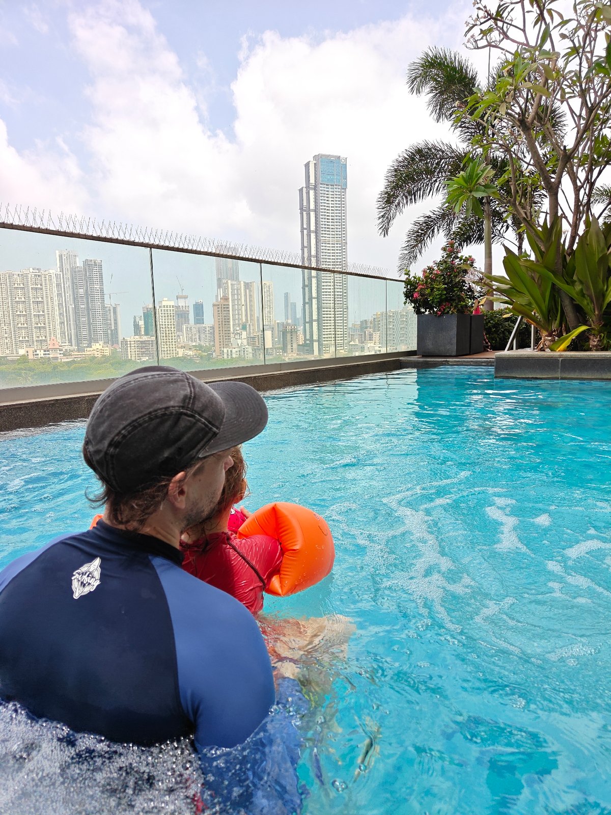 Father and child enjoy swimming session in Mumbai rooftop pool