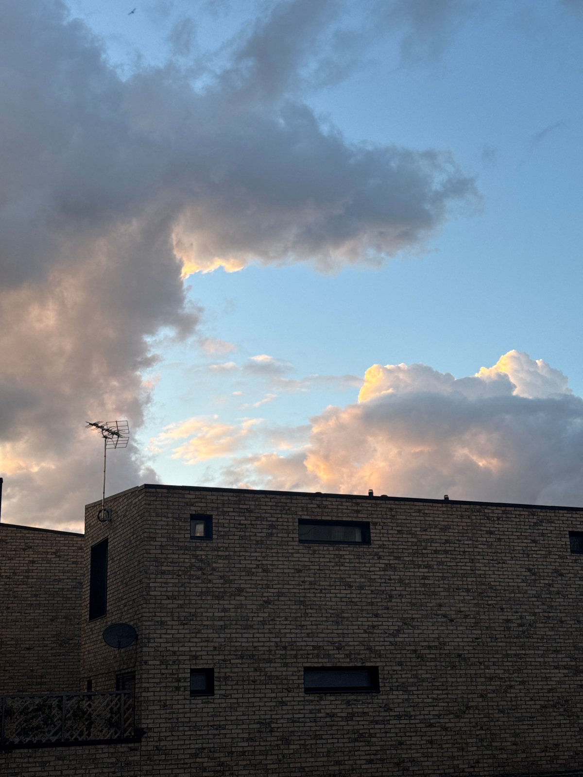 London brick building observed against cloudy evening sky