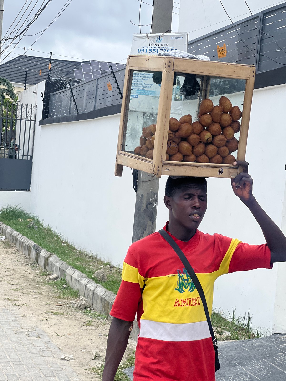 Street vendor sells fried dough balls in Igboefon, Nigeria