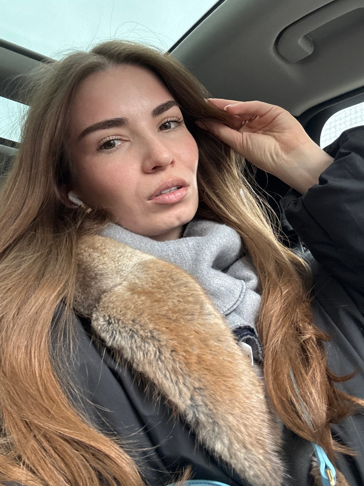 Woman observed in vehicle wearing jacket, earbud in Moscow