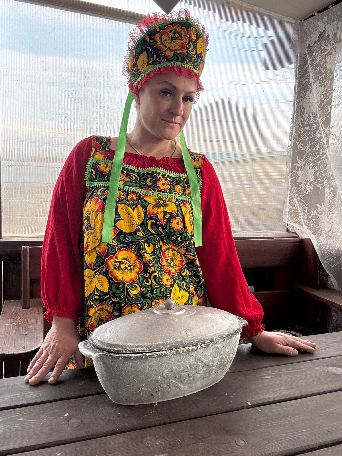 Woman in traditional Russian dress tends garden in Chaikovsky