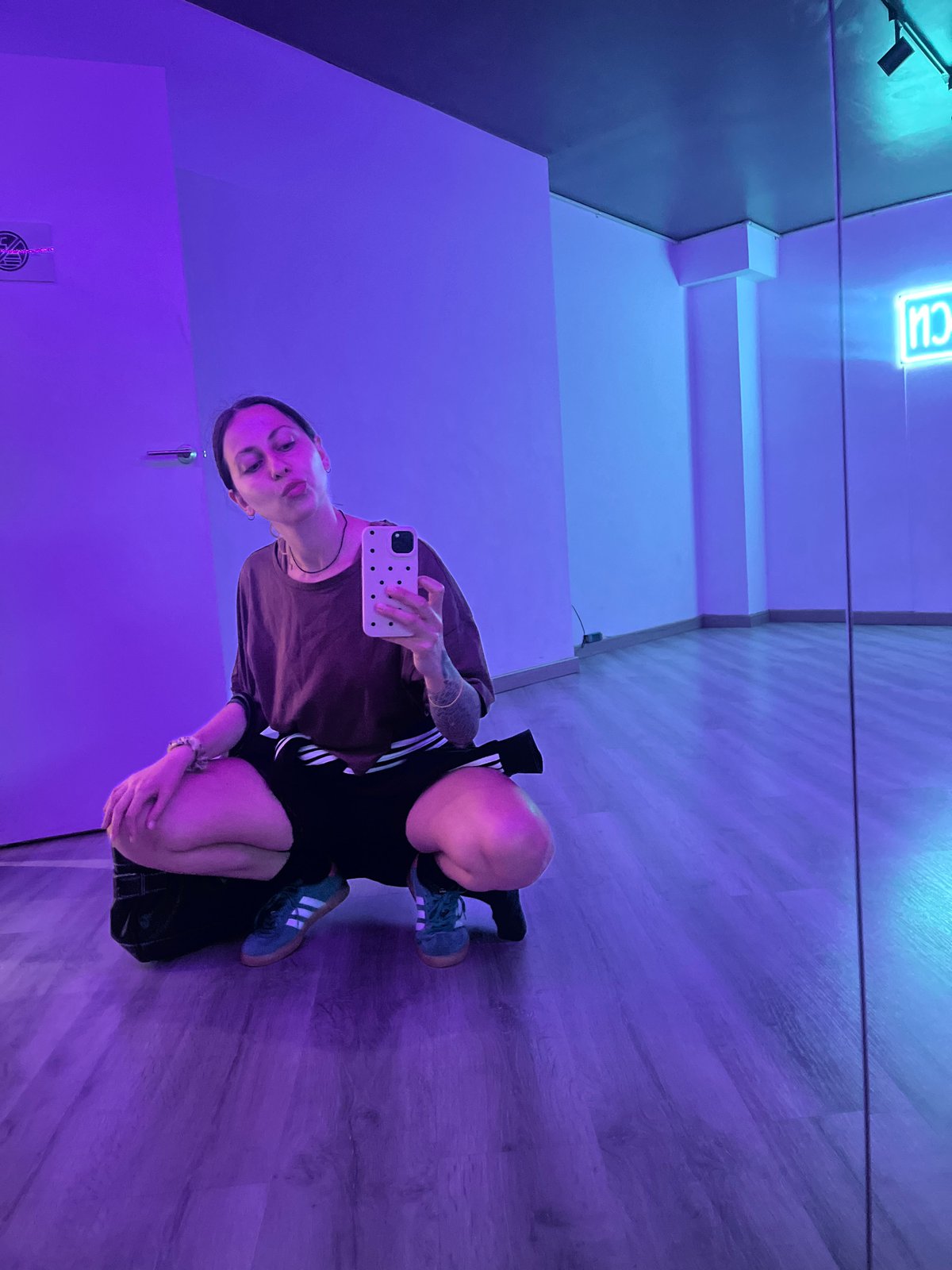 Barcelona studio selfie captured under colorful neon lighting