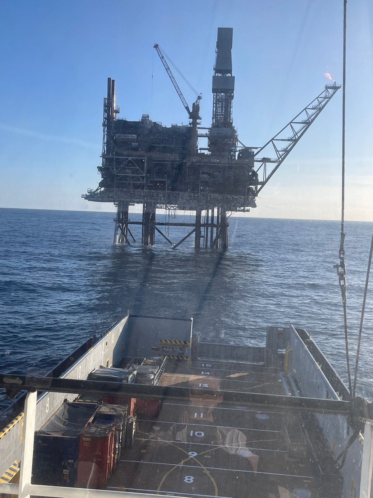Offshore oil platform with flare observed from vessel