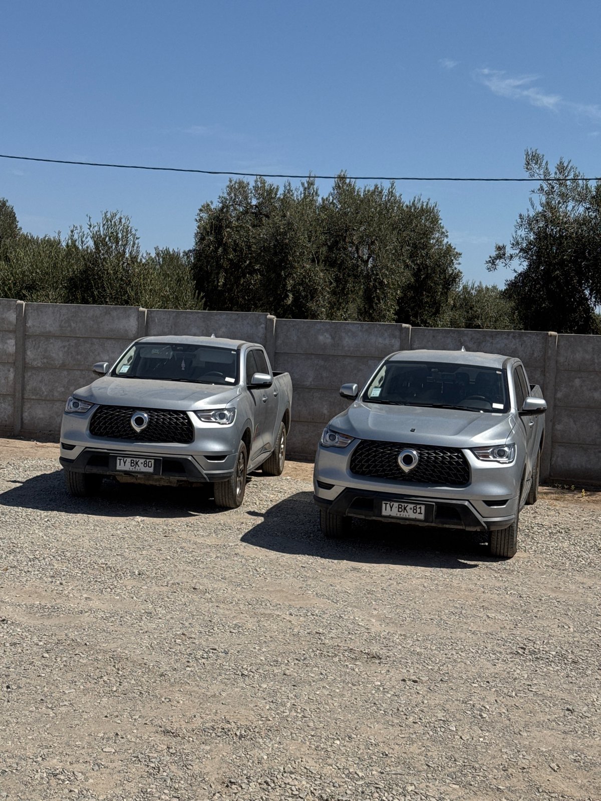 Two matching pickup trucks parked in Arica, Chile