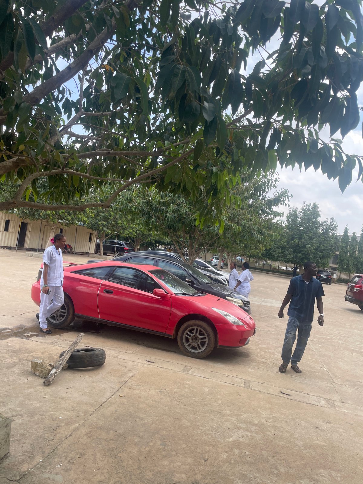Vehicles parked in an open compound, Abuja