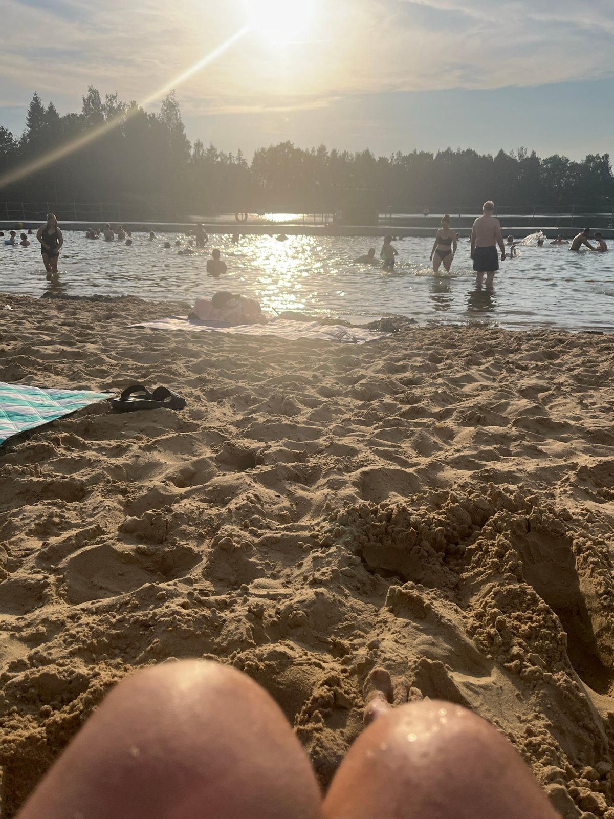 Sunny afternoon at a crowded beach or lake swimming spot