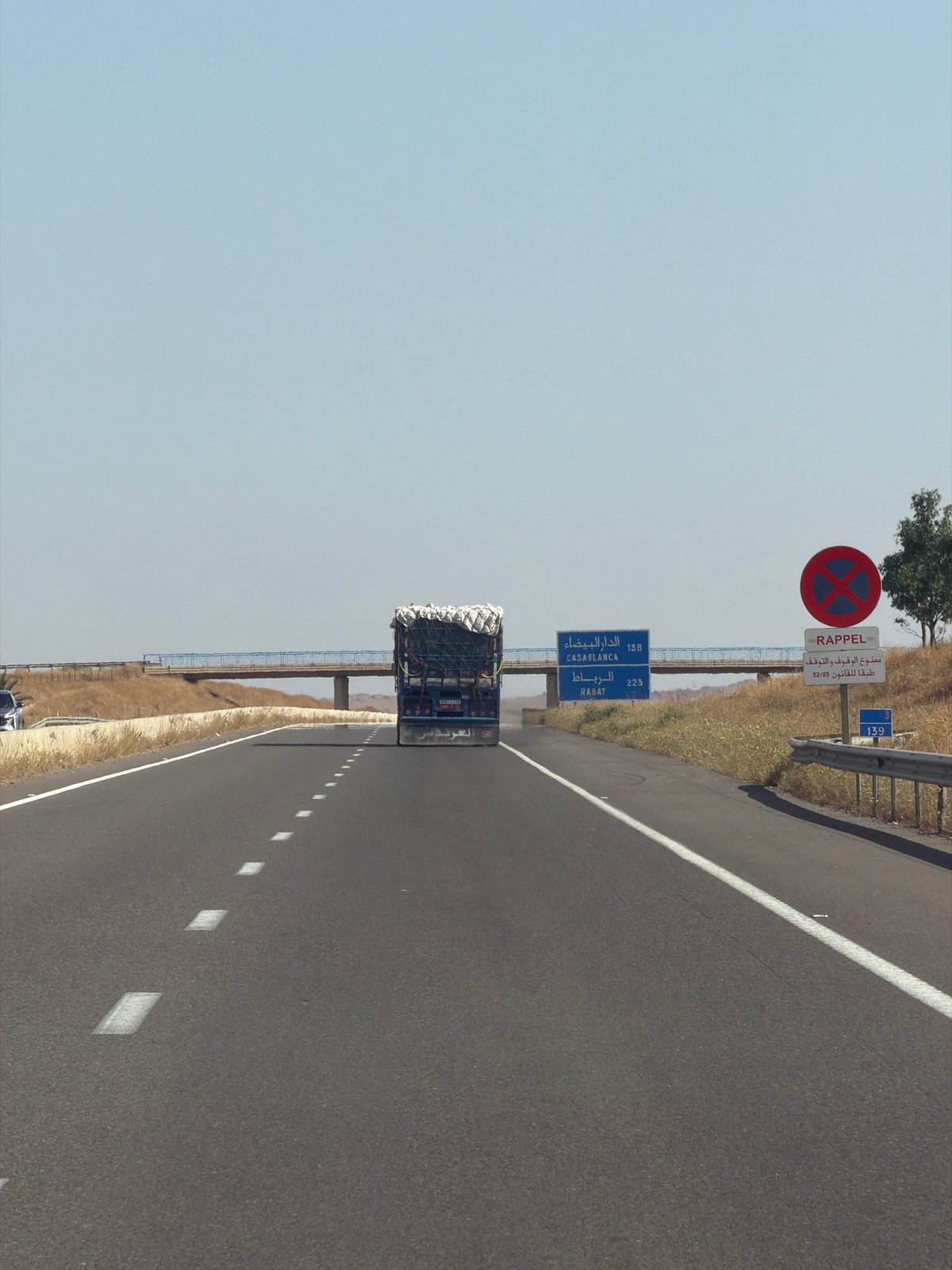Truck travels highway through rural Morocco farmland