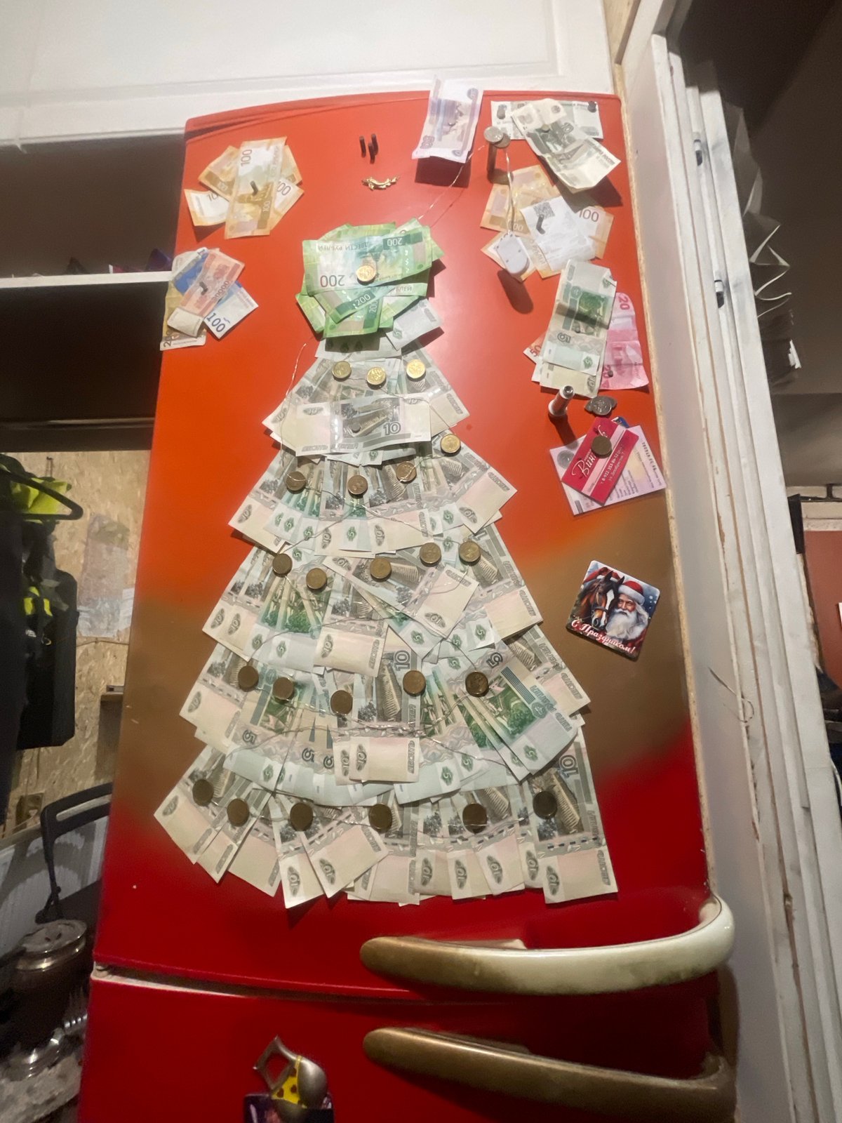 Russian refrigerator door decorated with ruble bills and coins