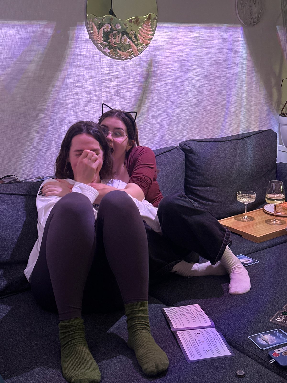 Two people relax on sofa in plant-filled home