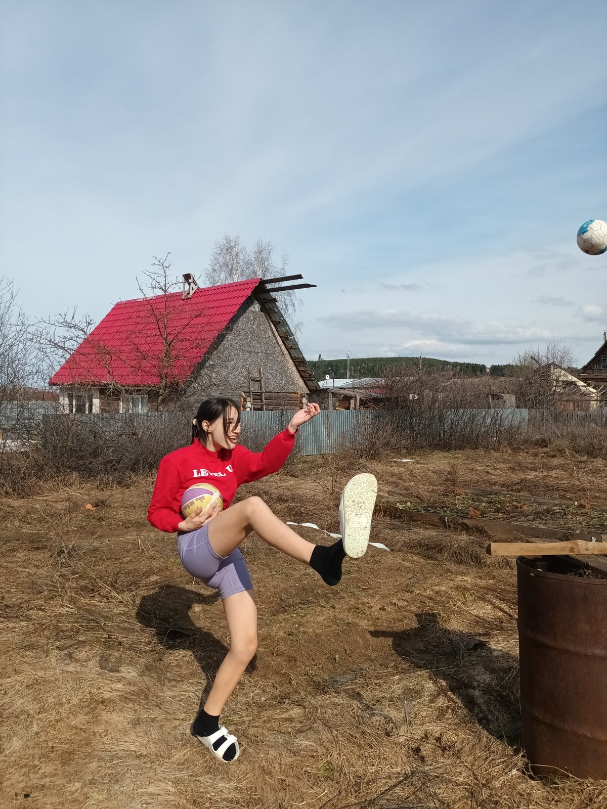 Person photographed at boat and dirt road in Ольховка