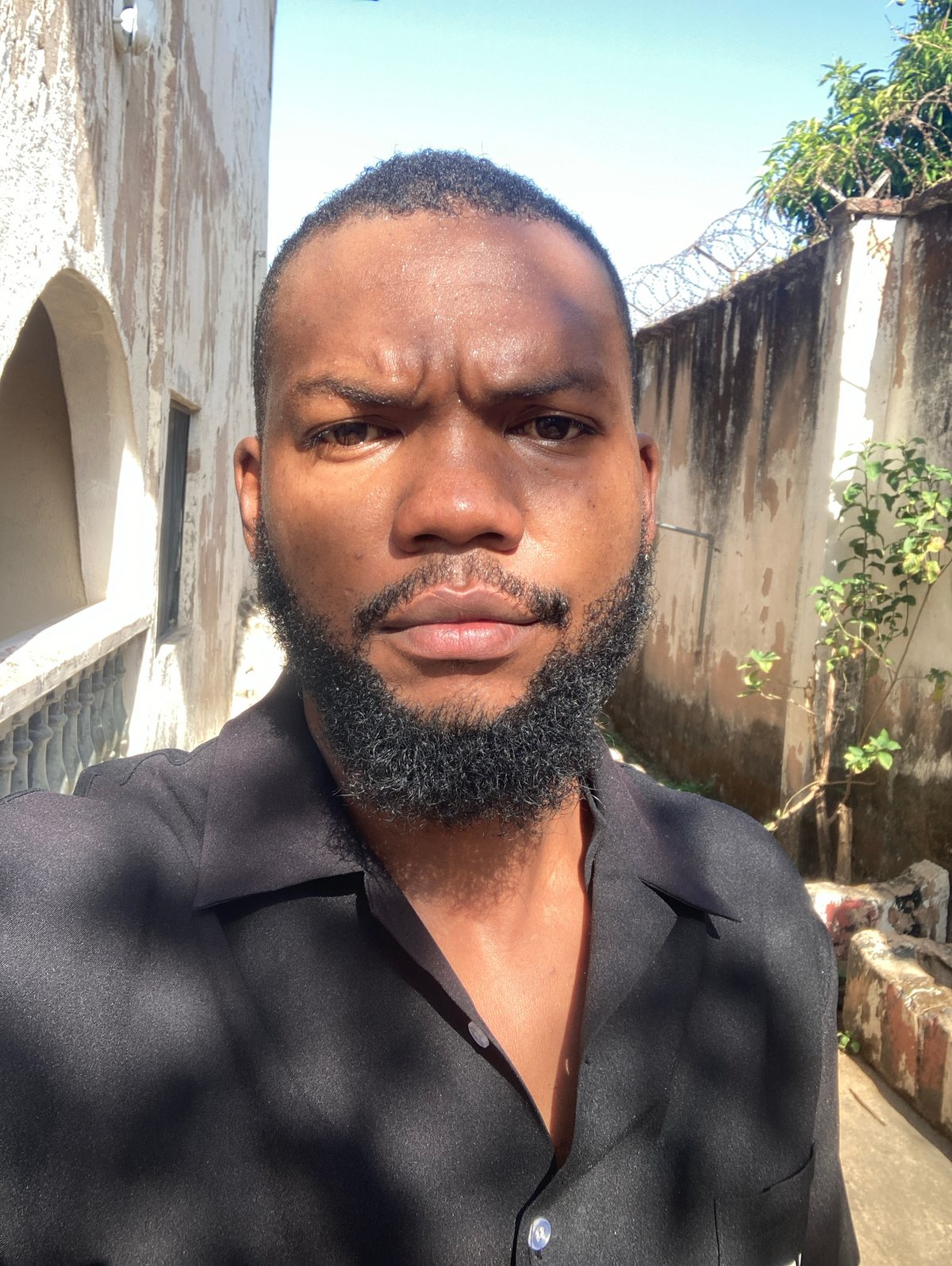Man in black shirt observed outdoors in Jos, Nigeria