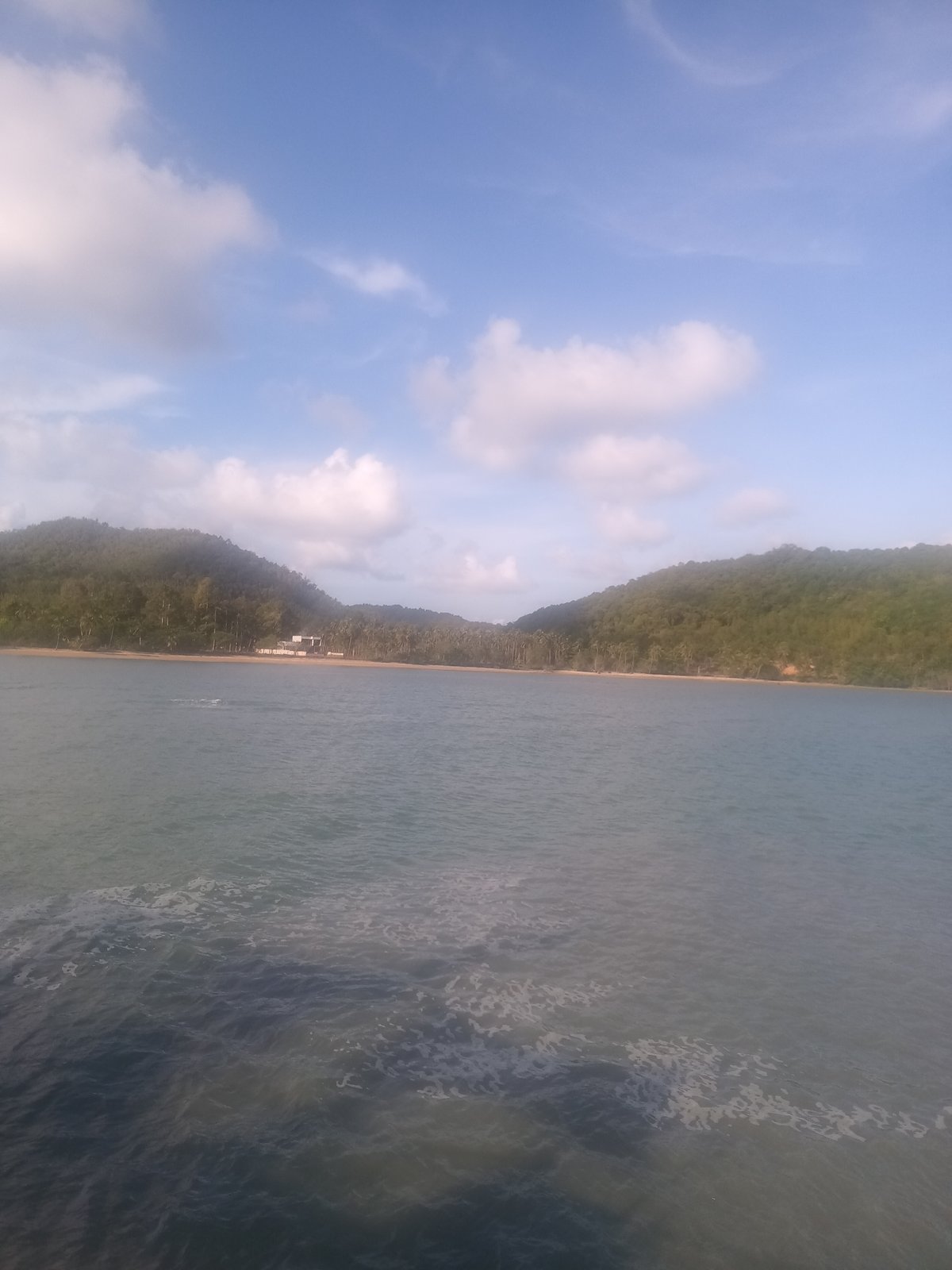Tourist documents ferry departure from Hat Sai Ri beach Thailand
