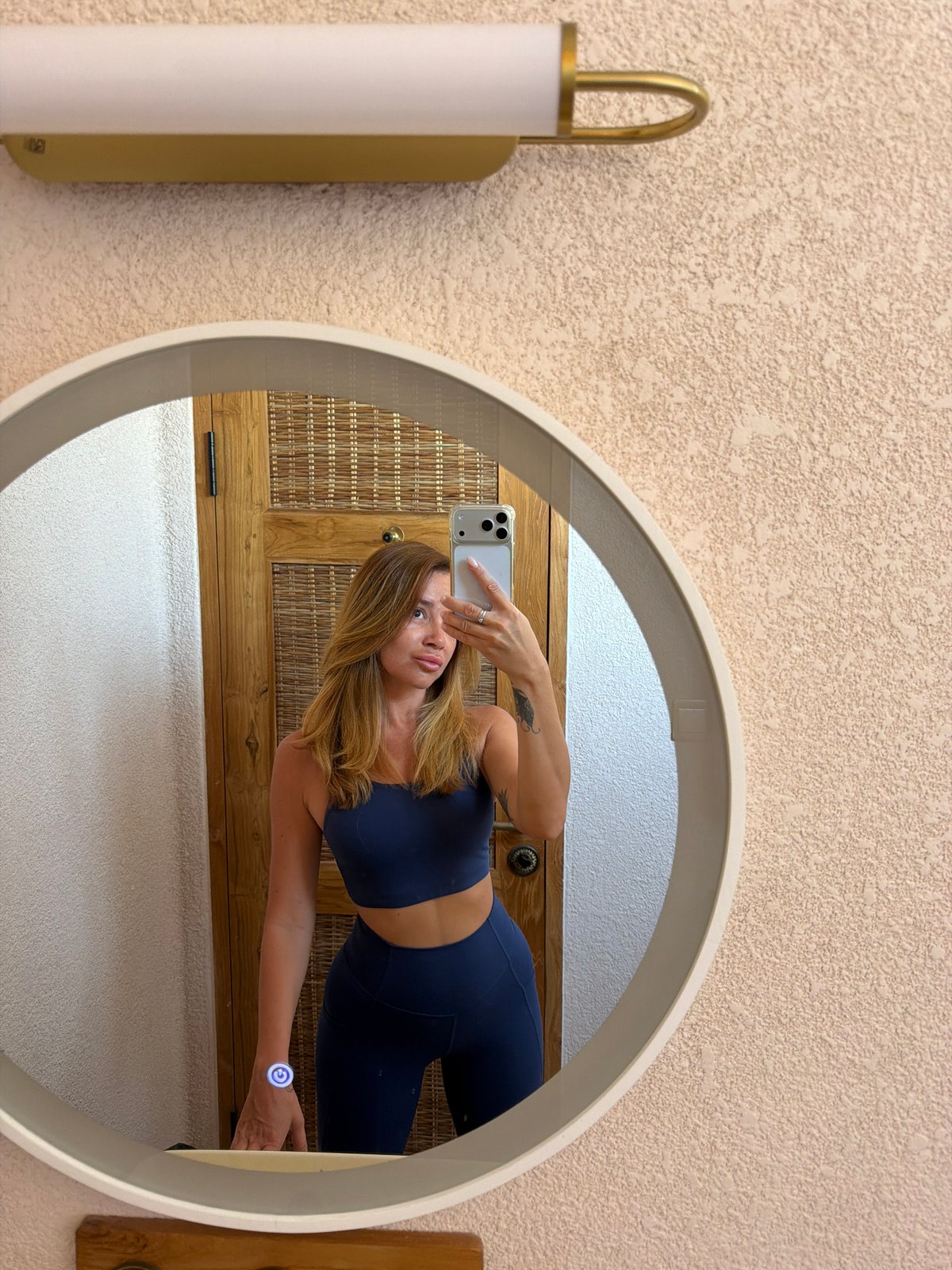 Mirror selfies with hair tools in a Mengwi bathroom
