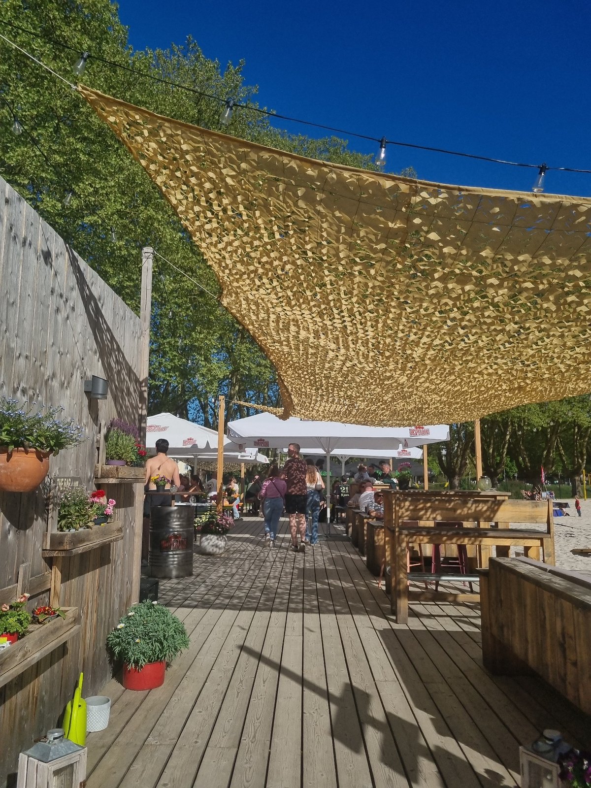 Friends gather for afternoon drinks at Saarbrücken beach volleyball venue