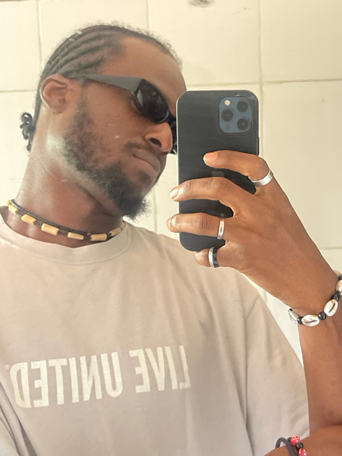 Man photographed twice in Jos wearing Live United shirt