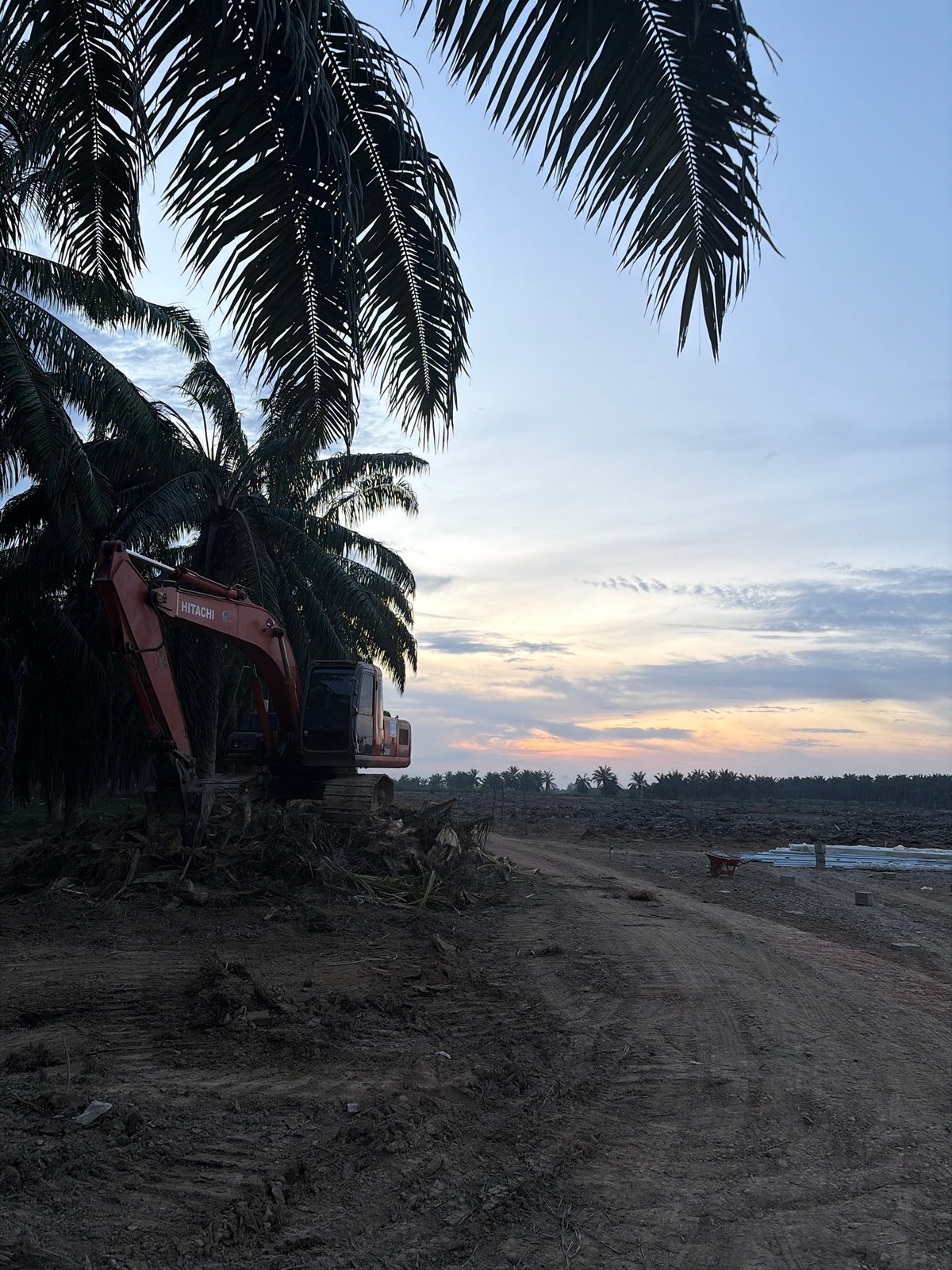 Construction site active in Simpangempat with excavator, workers