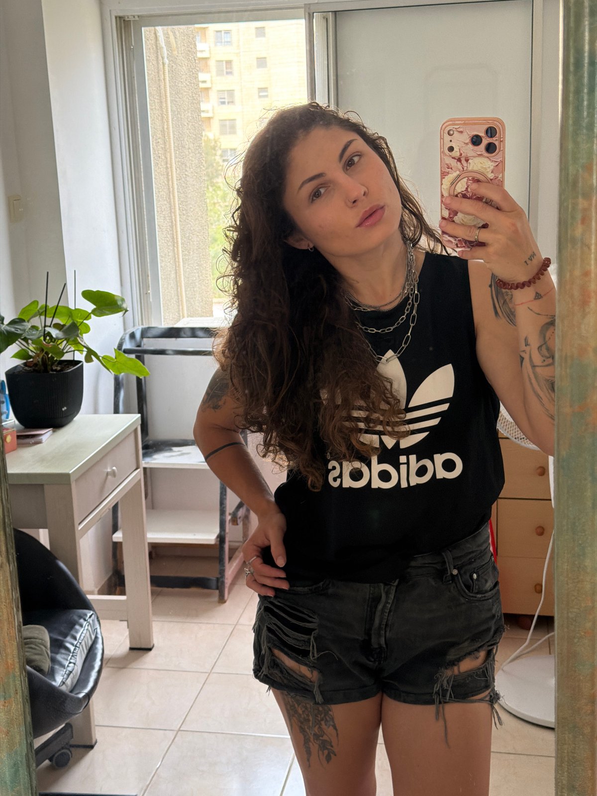 Woman takes morning selfies in Kiryat Bialik bathroom mirror