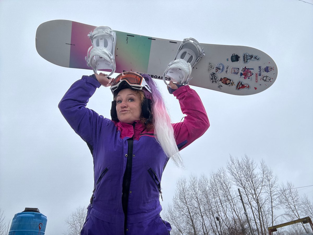 Snowboarder poses with gear in Chaikovsky, Russia