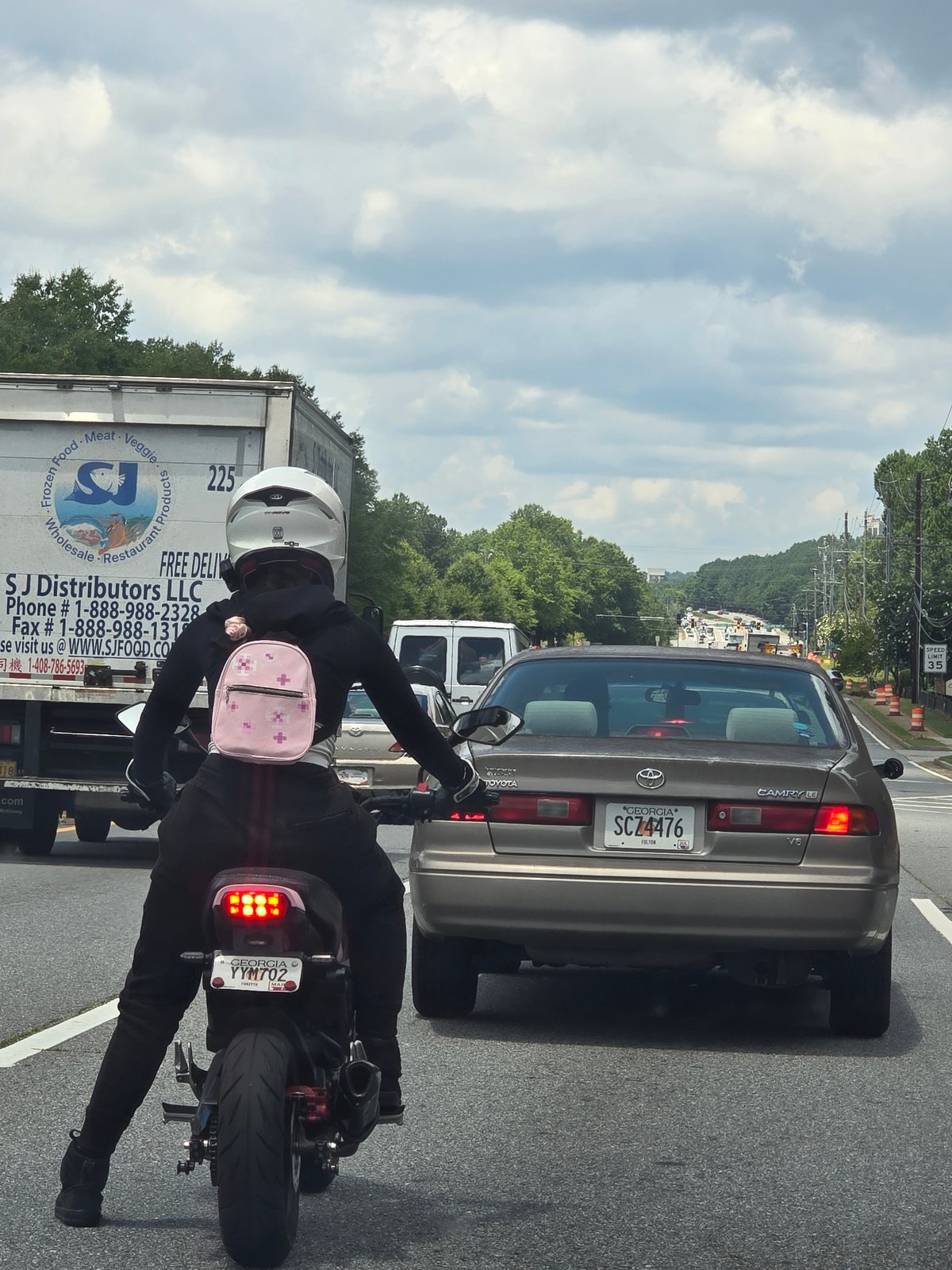 Two riders on a black motorcycle in Alpharetta, Georgia
