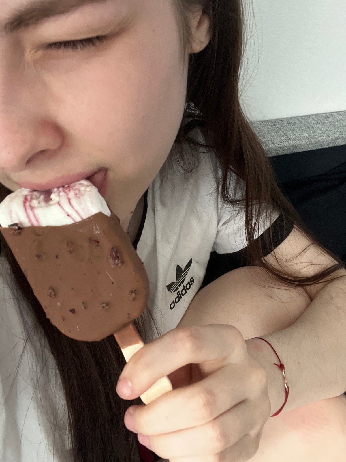 Person enjoys chocolate ice cream bar in Saint Petersburg