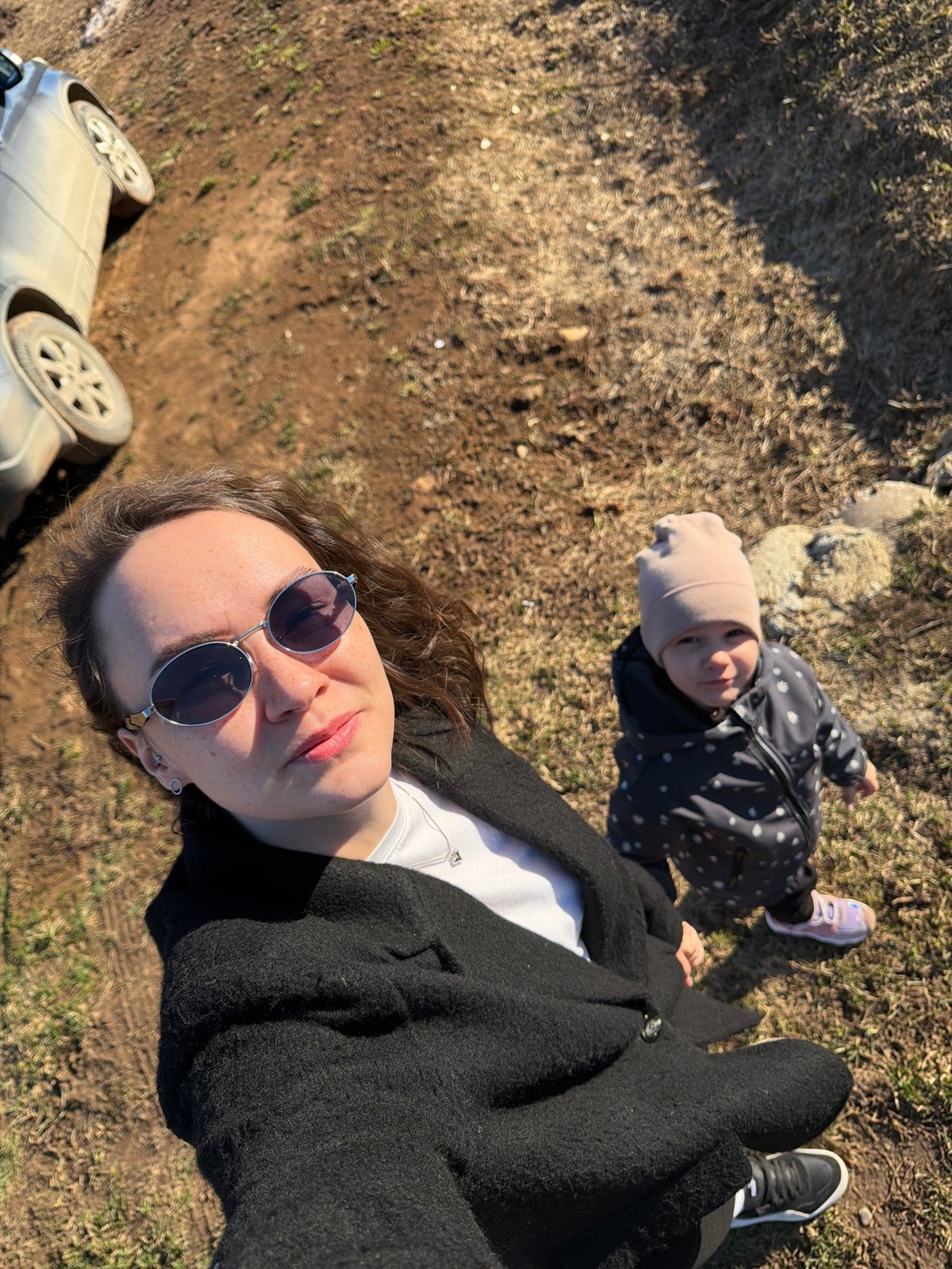 Woman and child rest outdoors in Russian countryside