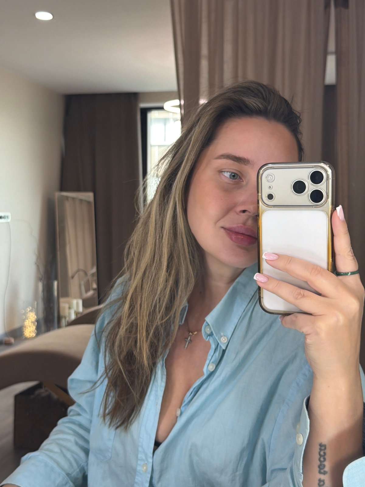 Woman takes selfie with gold phone in Moscow