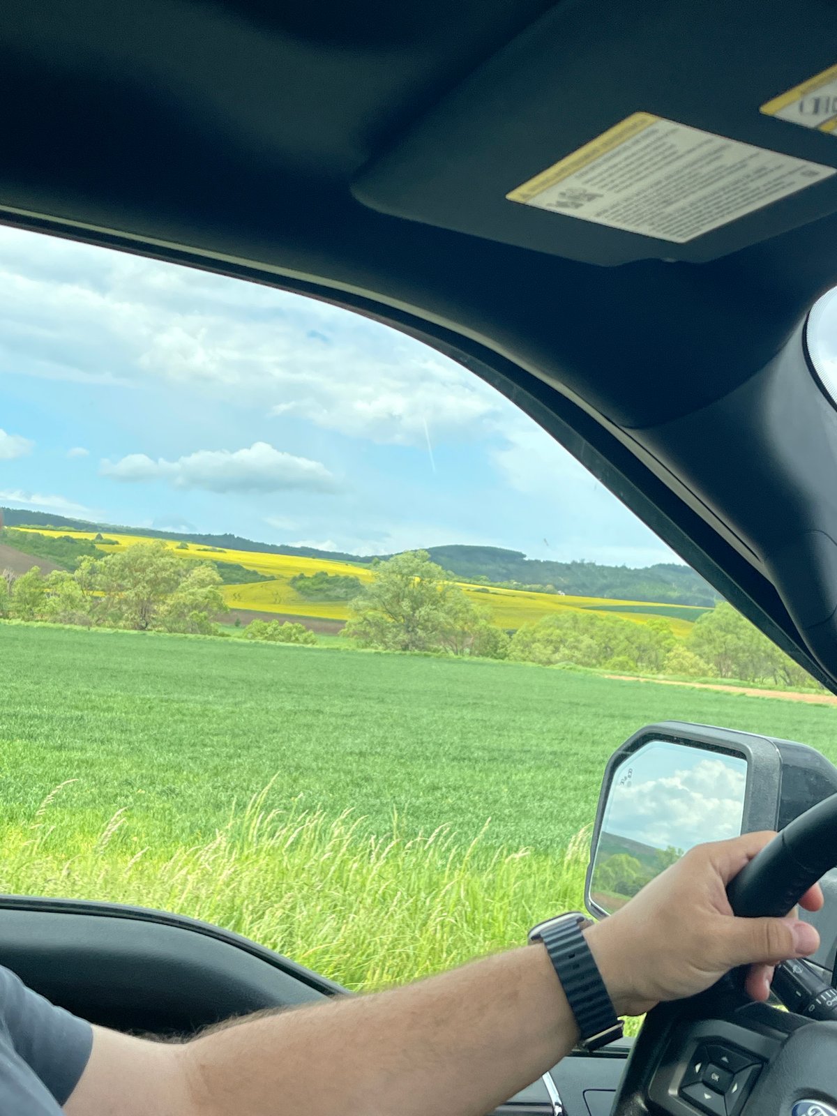 Driver travels through green countryside near Yardzhilovtsi, Bulgaria