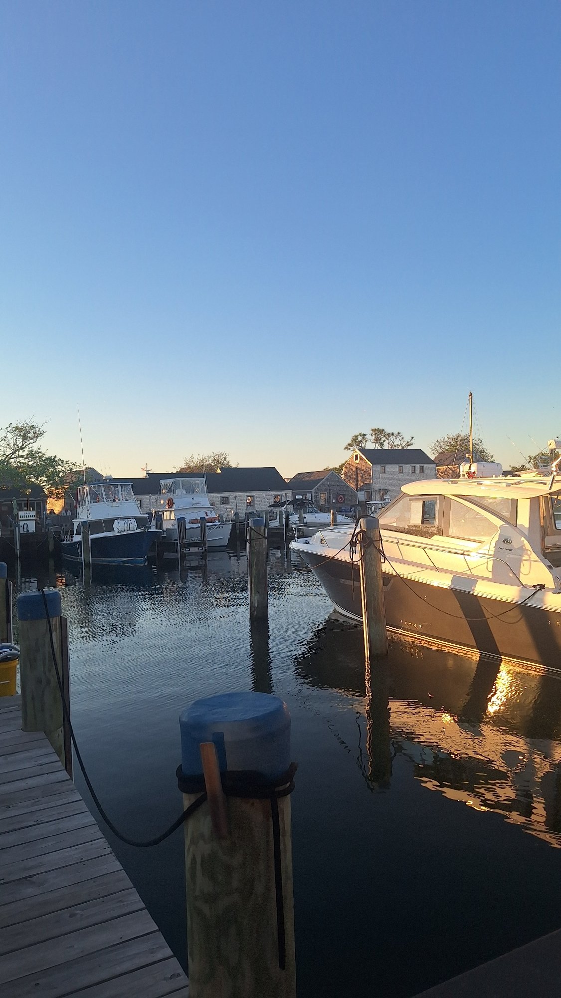 Sunset harbor views from Nantucket marina and wooden piers