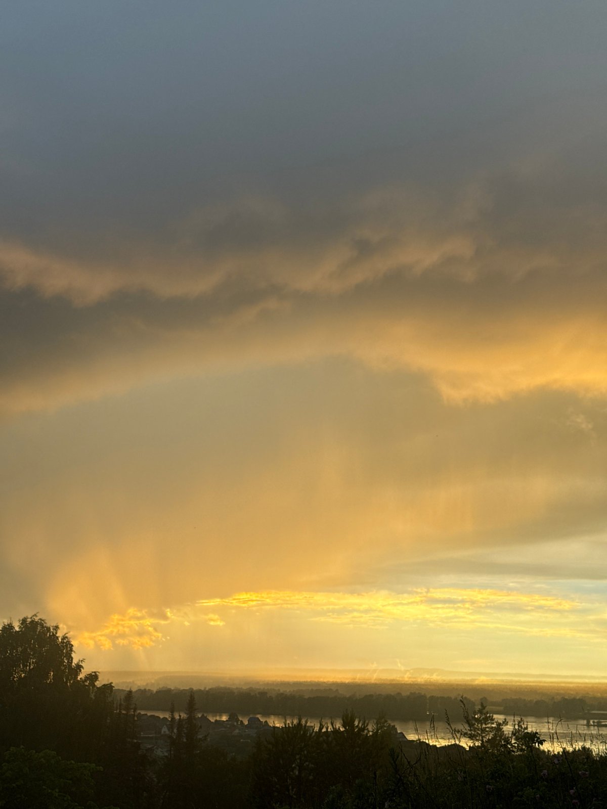 Dramatic sunset illuminates Russian villages amid stormy skies