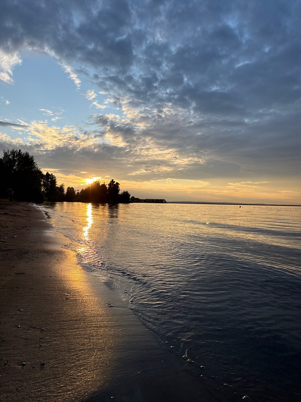 Friends enjoy sunset beach gathering in Chaikovsky, Russia