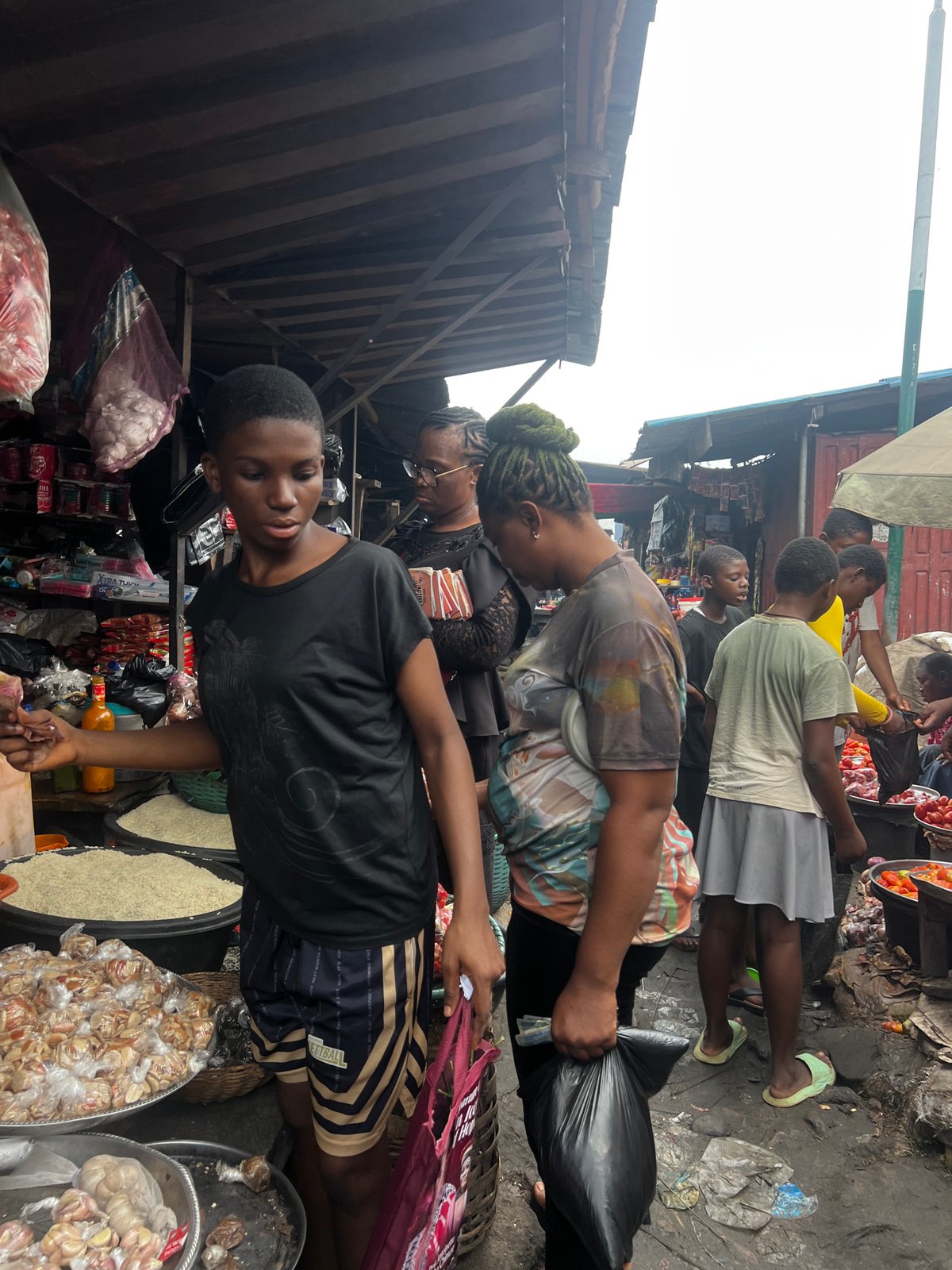 Nkpor market in full morning swing — produce, fabric, food stalls