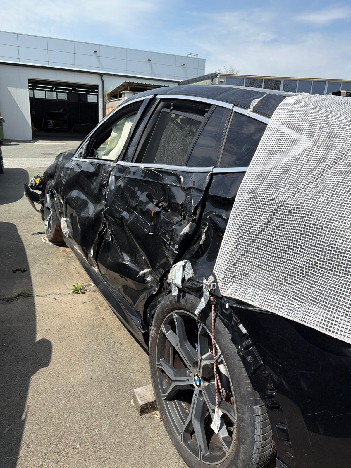 Damaged BMW and Toyota Supra documented at automotive workshop