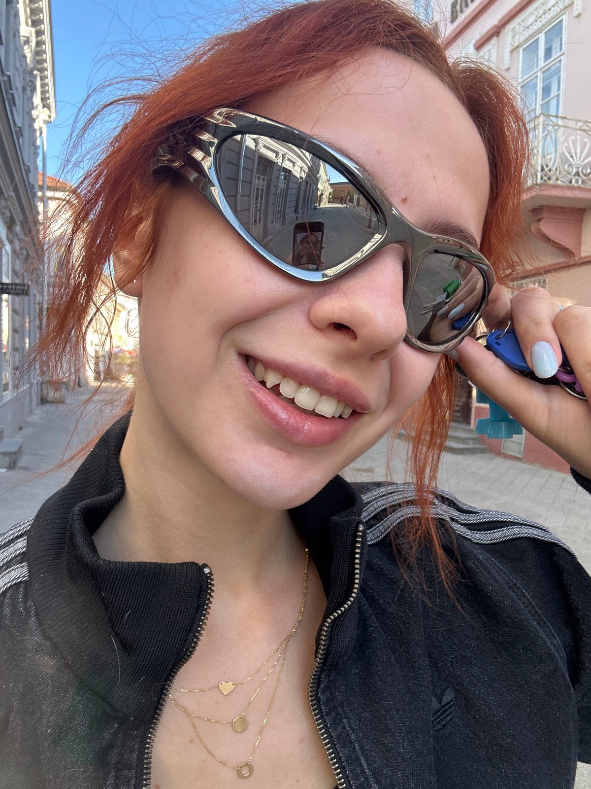 Woman photographed taking selfies in Novi Sad elevator, street