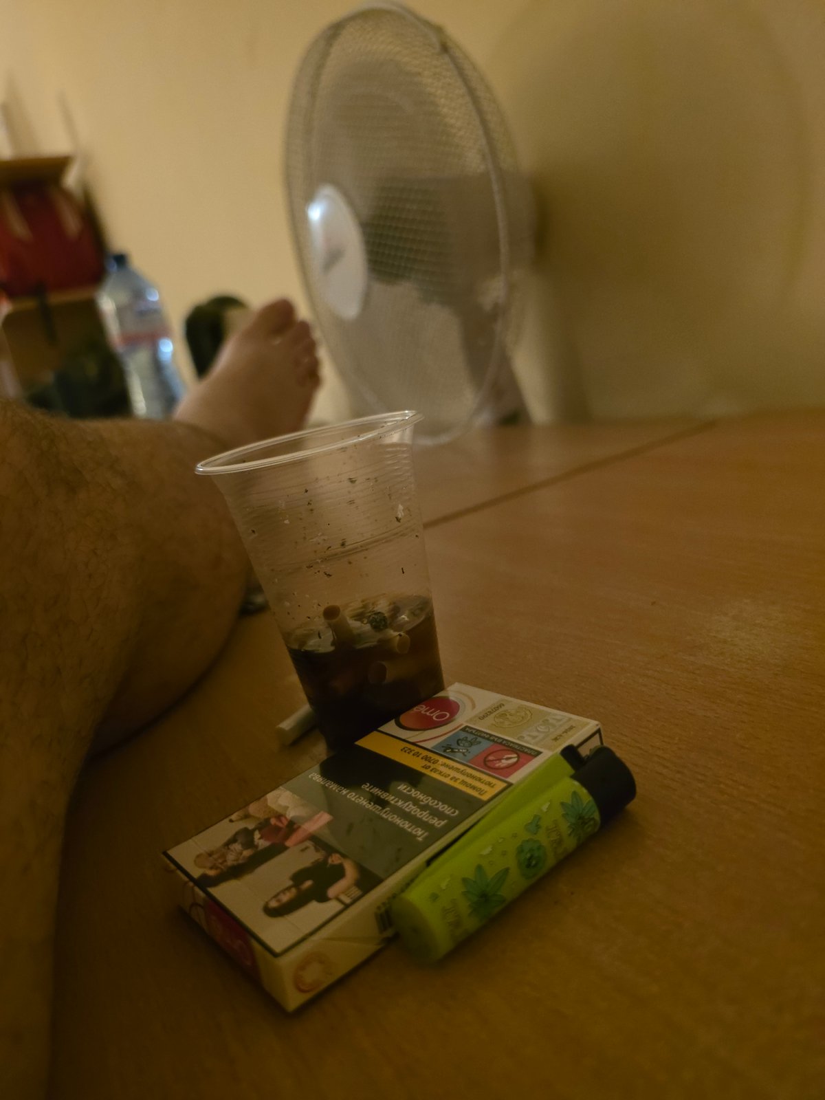 Quiet room scene in Veliko Tarnovo, cigarettes and bread on a wooden desk