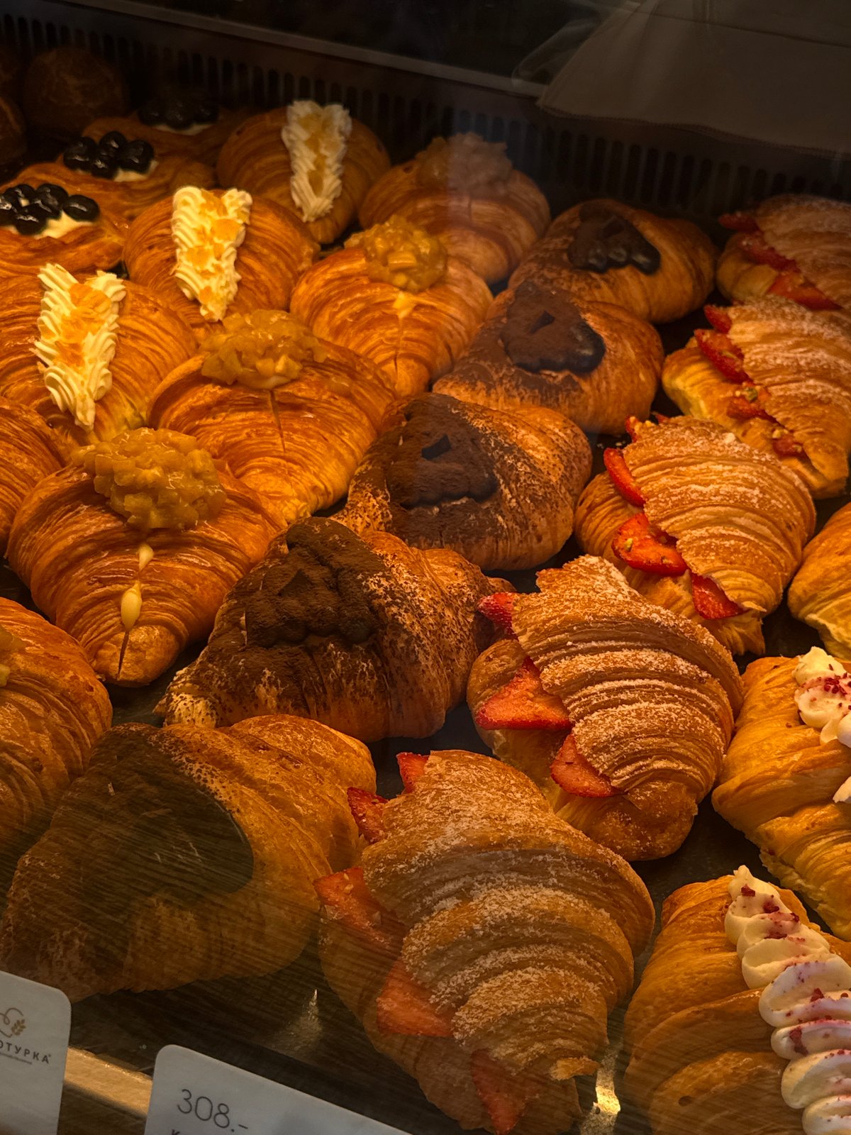 Morning bakery display photographed in Izhevsk showing assorted pastries